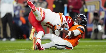 Nov 16, 2025; Denver, Colorado, USA; Denver Broncos cornerback Ja'Quan McMillian (29) sacks Kansas City Chiefs quarterback Patrick Mahomes (15) in the fourth quarter at Empower Field at Mile High. Mandatory Credit: Ron Chenoy-Imagn Images